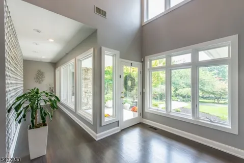 a view of entryway with window and wooden floor