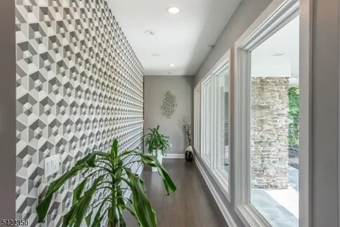 a hallway with a plant in front of a window