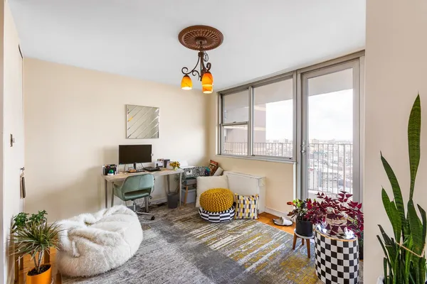 a very nice looking living room with a large window and a chandelier