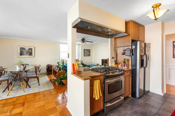 a kitchen with stainless steel appliances granite countertop a stove and a refrigerator