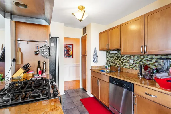 a kitchen with stainless steel appliances a sink stove and refrigerator
