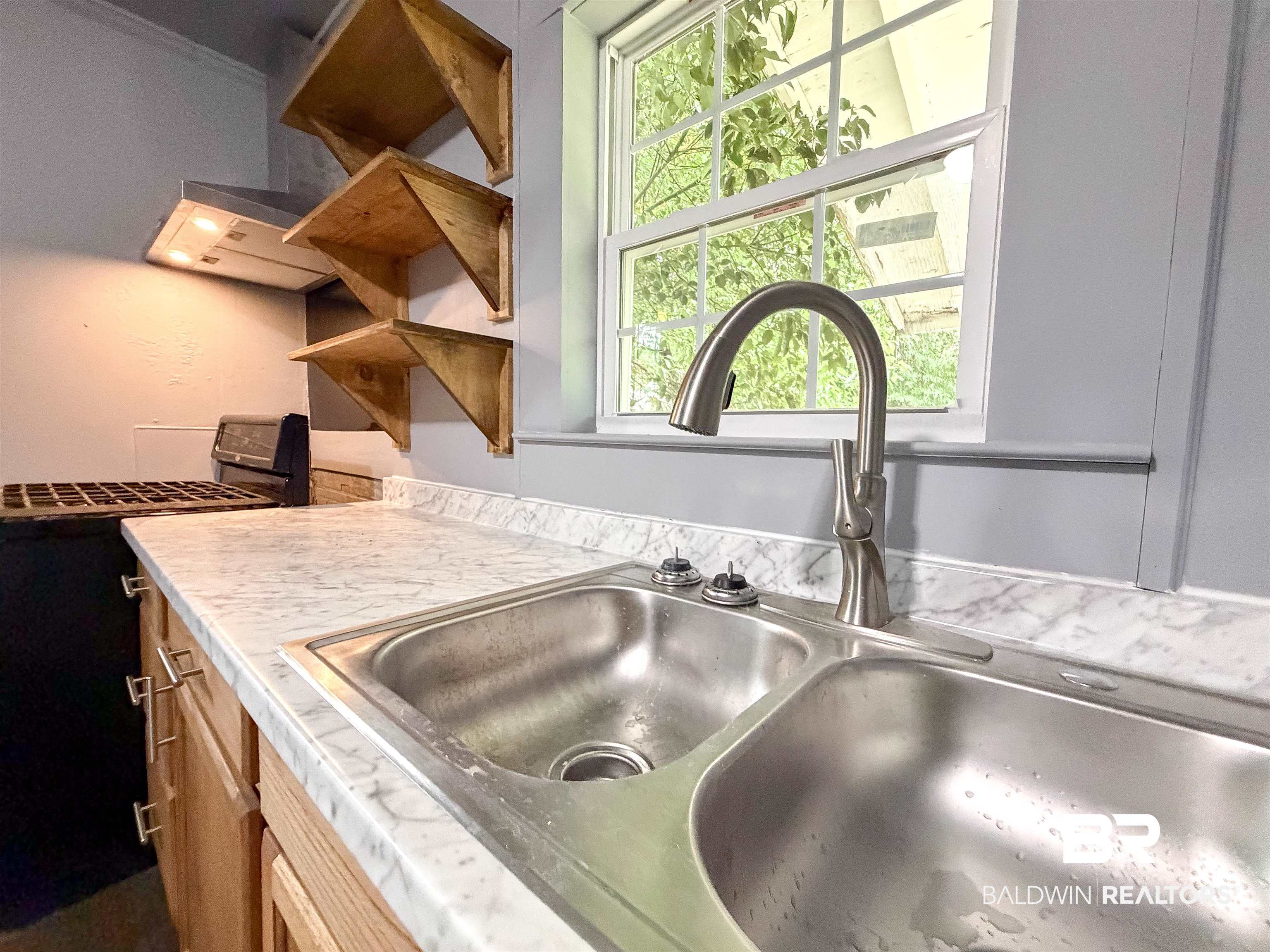 38 Flock Avenue Mobile, AL 36610 - Photo 7 of 27 Kitchen workspace featuring a double-basin stainless steel sink with a gooseneck faucet