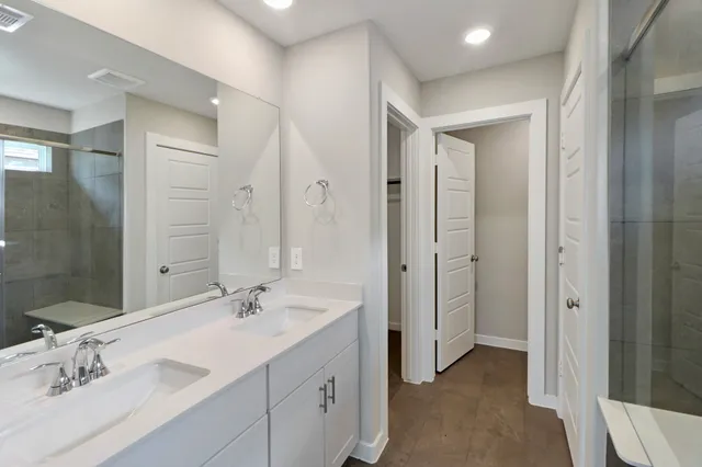 a spacious bathroom with a double vanity sink mirror and double