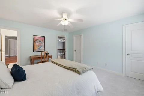 a bedroom with two beds and a chandelier