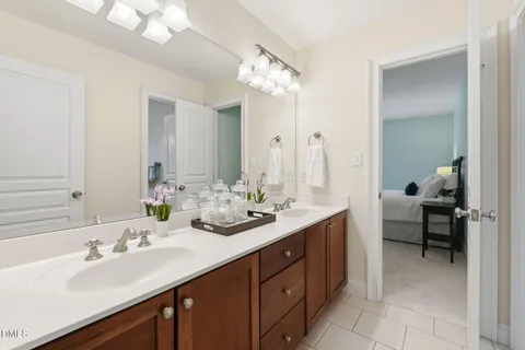 a bathroom with a sink a toilet a mirror a vanity and shower