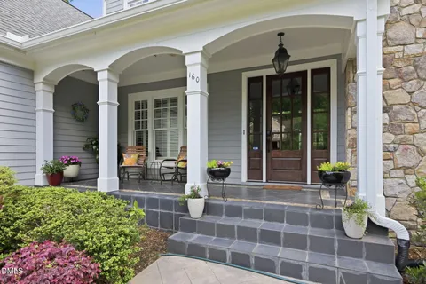 a front view of a house with outdoor seating and plants