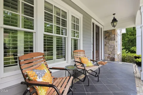 a view of a garden with a chair and a potted plant