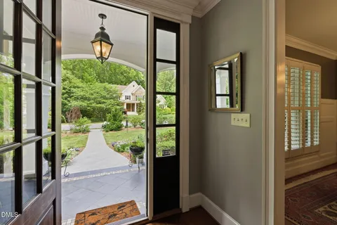 a hallway with wooden floor and furniture