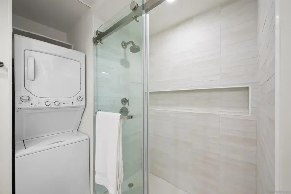 a bathroom with a shower a toilet and a sink