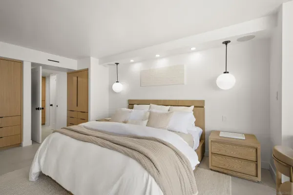 a bedroom with a bed and a chandelier