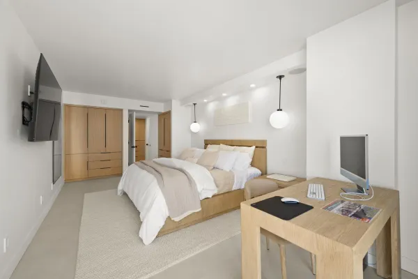 a bedroom with a bed and a flat screen tv