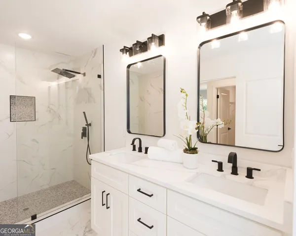 a bathroom with a shower sink and mirror