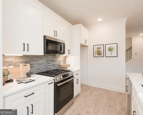 a kitchen with stainless steel appliances a stove microwave and cabinets