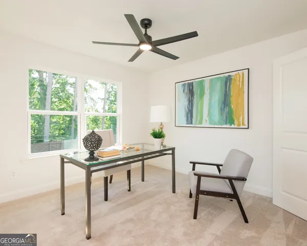 a hallway with a large window and couch
