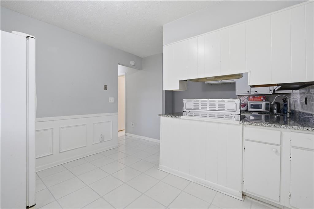 936 6 Oaks Circle, Unit B Norcross, GA 30093 - Photo 12 of 26 a kitchen with white cabinets and sink