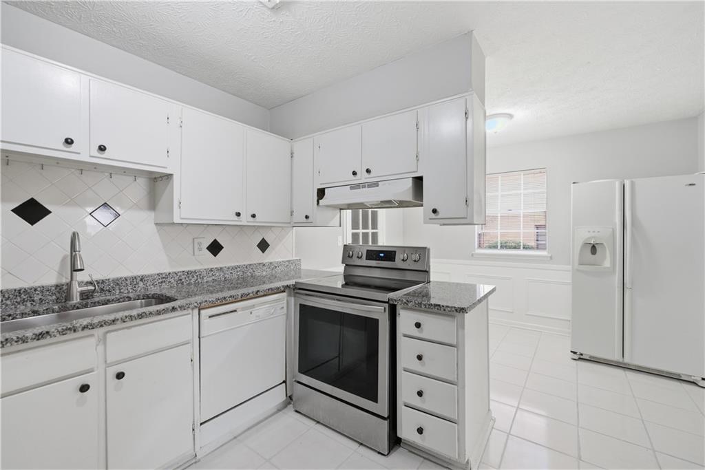 936 6 Oaks Circle, Unit B Norcross, GA 30093 - Photo 15 of 26 a kitchen with cabinets stainless steel appliances and a sink