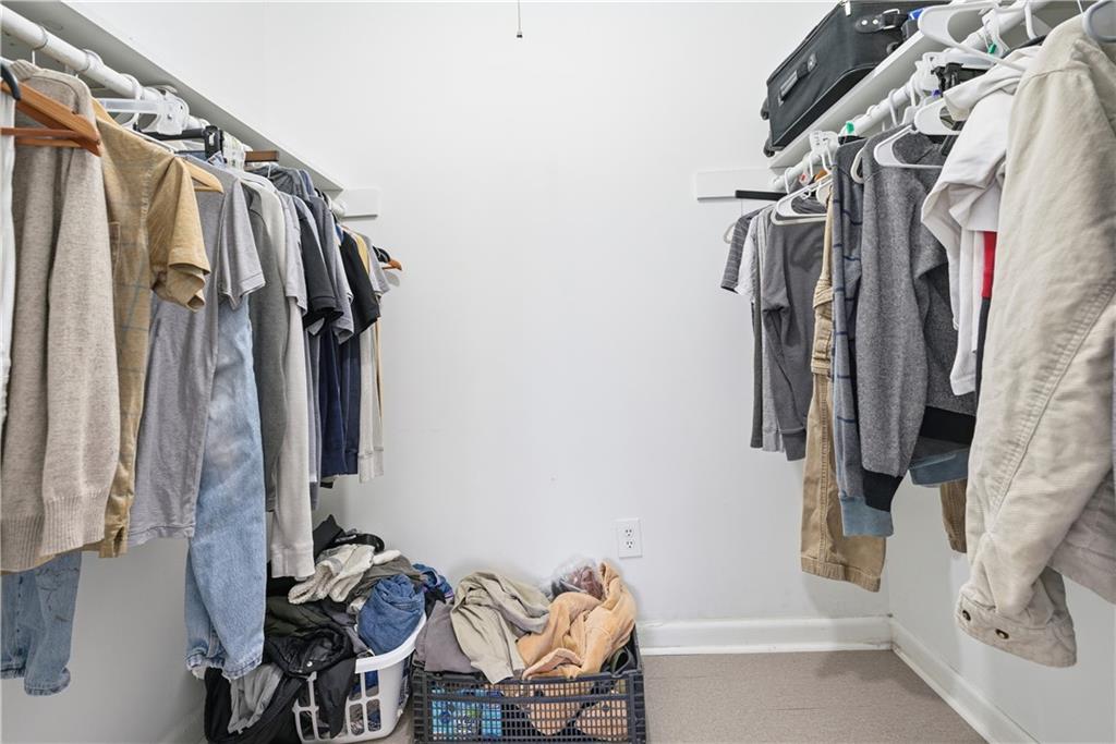 936 6 Oaks Circle, Unit B Norcross, GA 30093 - Photo 20 of 26 a view of walk in closet with clothes and shoes
