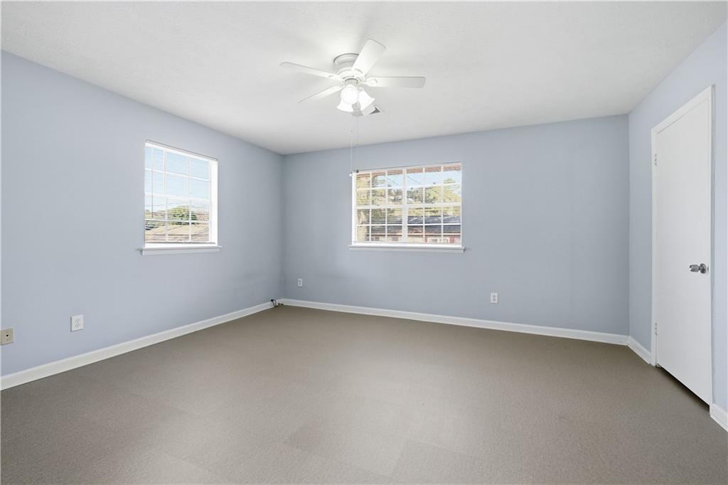 936 6 Oaks Circle, Unit B Norcross, GA 30093 - Photo 6 of 26 an empty room with windows and ceiling fan