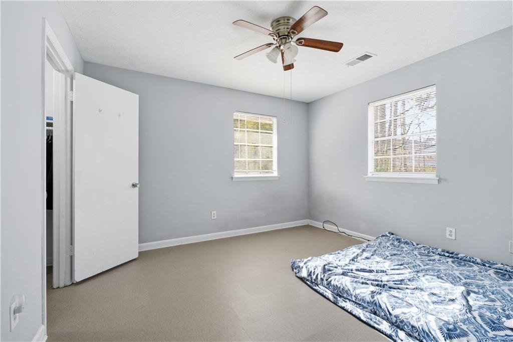 936 6 Oaks Circle, Unit B Norcross, GA 30093 - Photo 9 of 26 a view of a big room with windows and chandelier fan