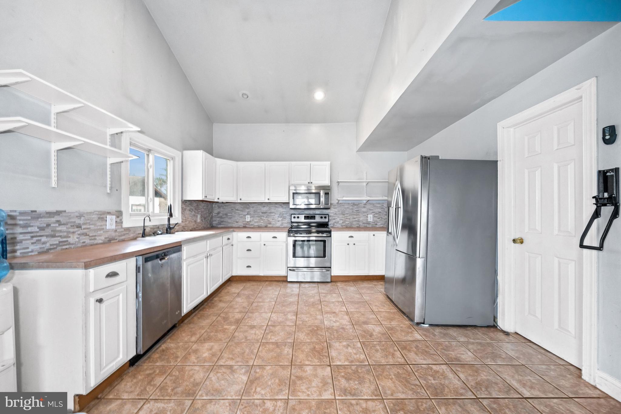 198 Cayots Corner Road Chesapeake City, MD 21915 - Photo 11 of 22 a large kitchen with cabinets and stainless steel appliances