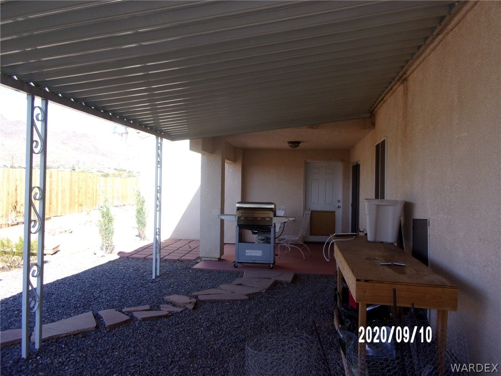 303 Bouse Road Golden Valley, AZ 86413 - Photo 15 of 42 a living room with furniture a fireplace and a table