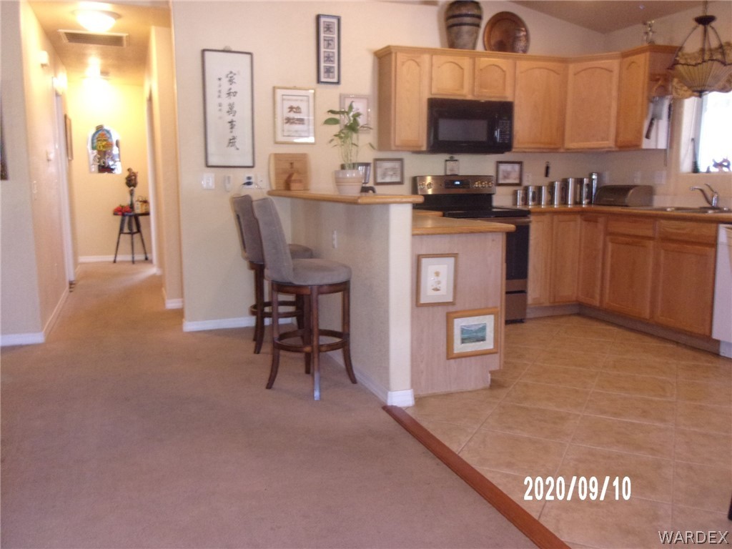 303 Bouse Road Golden Valley, AZ 86413 - Photo 19 of 42 a kitchen with stainless steel appliances granite countertop a sink counter space and cabinets