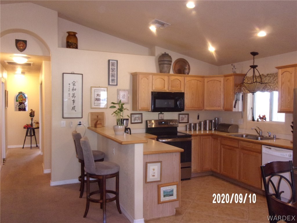 303 Bouse Road Golden Valley, AZ 86413 - Photo 20 of 42 a kitchen with granite countertop a sink appliances cabinets and furniture