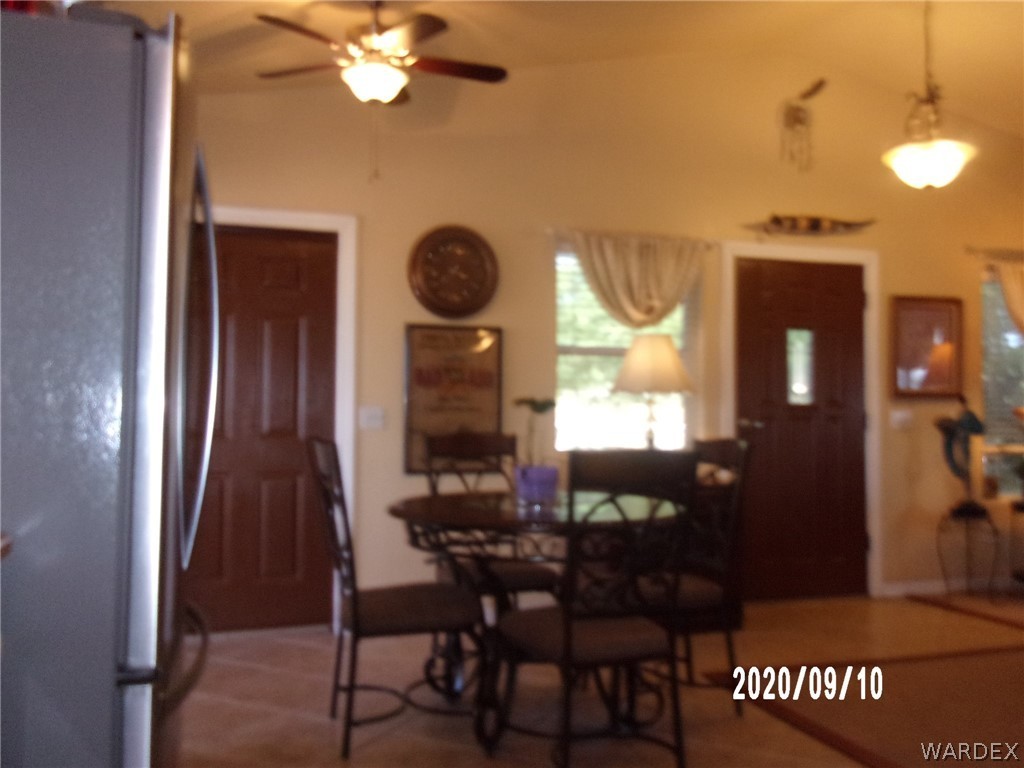 303 Bouse Road Golden Valley, AZ 86413 - Photo 24 of 42 a view of a dining room with furniture and chandelier