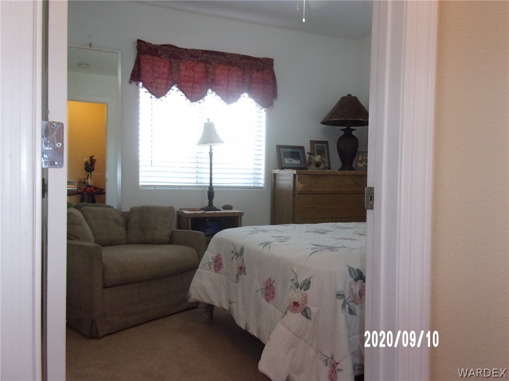 303 Bouse Road Golden Valley, AZ 86413 - Photo 32 of 42 a bedroom with a bed and a window