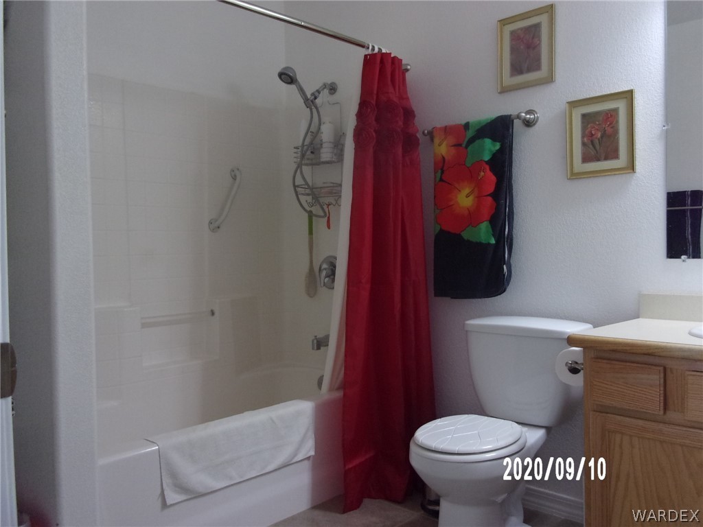 303 Bouse Road Golden Valley, AZ 86413 - Photo 34 of 42 a bathroom with a toilet and a shower curtain