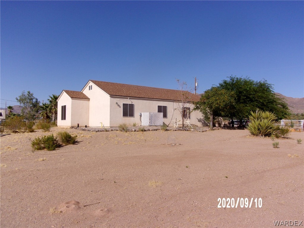 303 Bouse Road Golden Valley, AZ 86413 - Photo 40 of 42 a view of a house with a snow in the yard