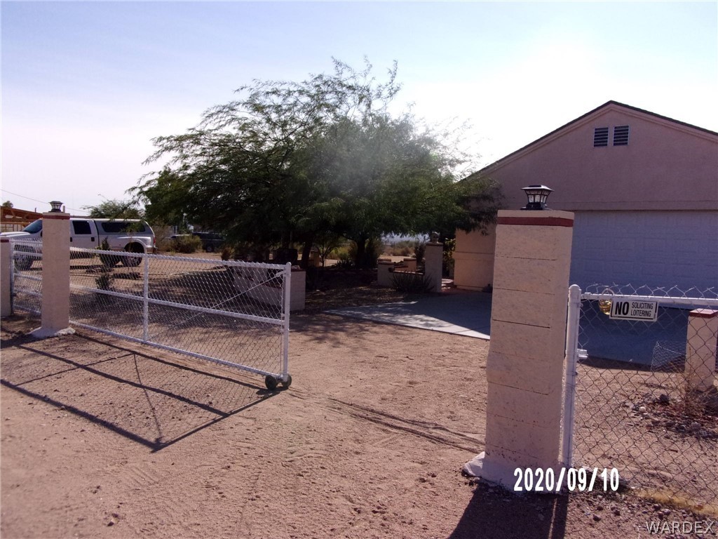 303 Bouse Road Golden Valley, AZ 86413 - Photo 4 of 42 a backyard of a house with barbeque oven and outdoor seating