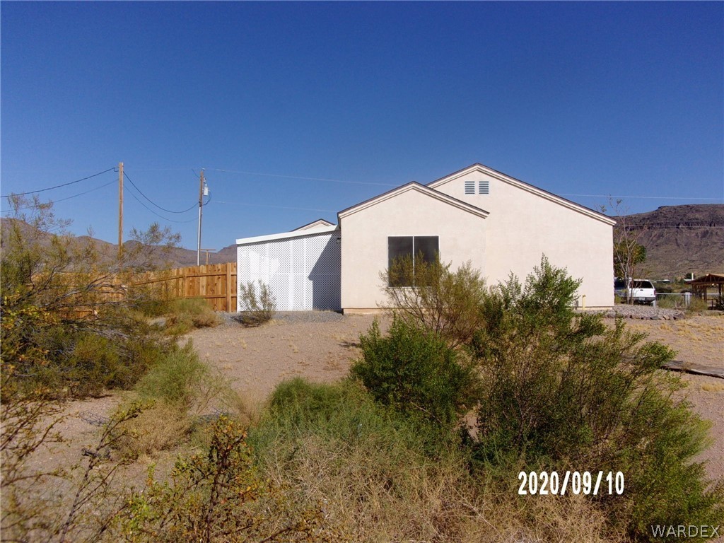 303 Bouse Road Golden Valley, AZ 86413 - Photo 41 of 42 a view of a house with a yard