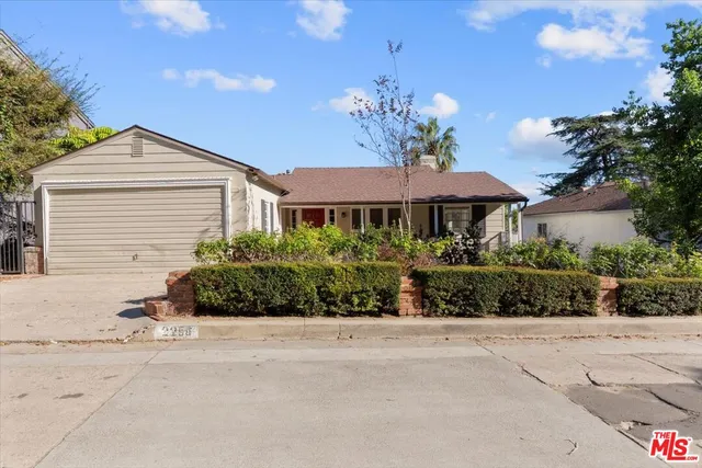 a front view of a house with a yard and outdoor seating