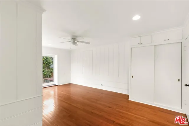 a view of a big room with wooden floor and windows in a room