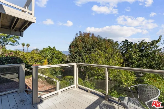 a view of a patio with table and chairs and potted plants