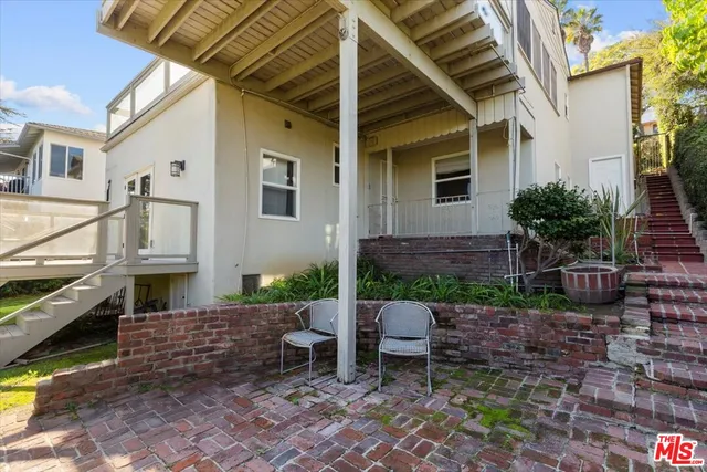 a view of a house with backyard and sitting area