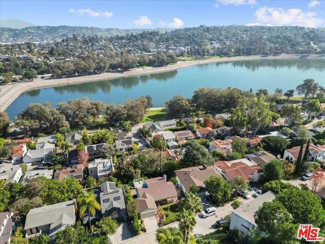 an aerial view of a houses with outdoor space and lake view