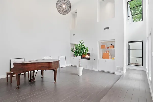 a view of a workspace with furniture and wooden floor