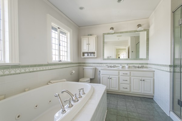 230 Buckminster Road Brookline, MA 02445 - Photo 14 of 19 a bathroom with a bathtub sink and mirror