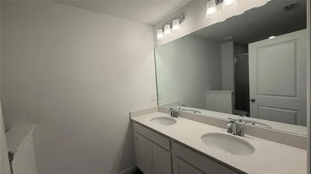 a bathroom with a shower a toilet and a sink