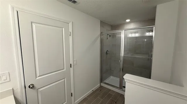 a bathroom with a shower and toilet