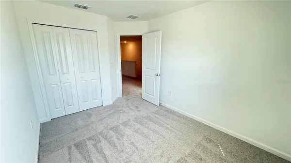 a bathroom with a bathtub shower sink vanity mirror and toilet