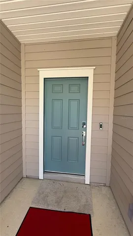 a kitchen with refrigerator cabinets and wooden floor