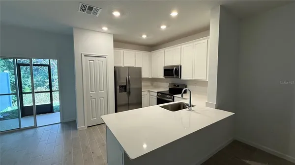 a kitchen with refrigerator and window