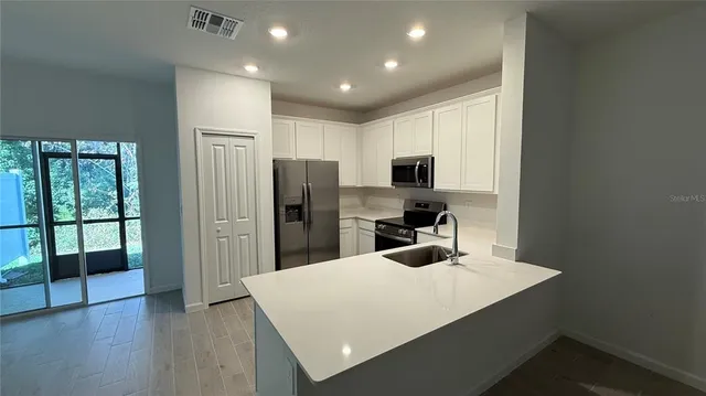 a kitchen with refrigerator and window