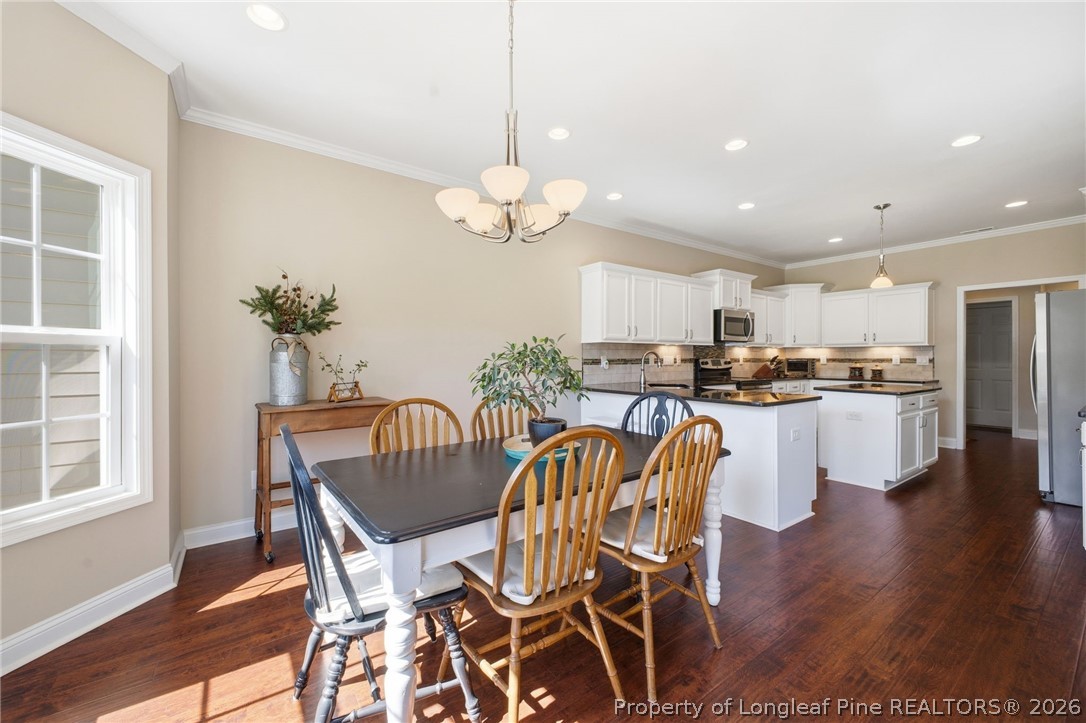 2589 June Johnson Road Raeford, NC 28376 - Photo 8 of 49 a view of a dining room with furniture and wooden floor