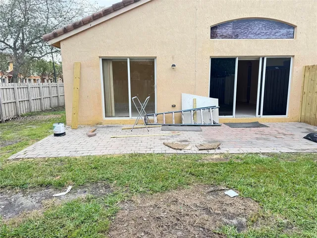 a view of a hallway with wooden floor and a bathroom