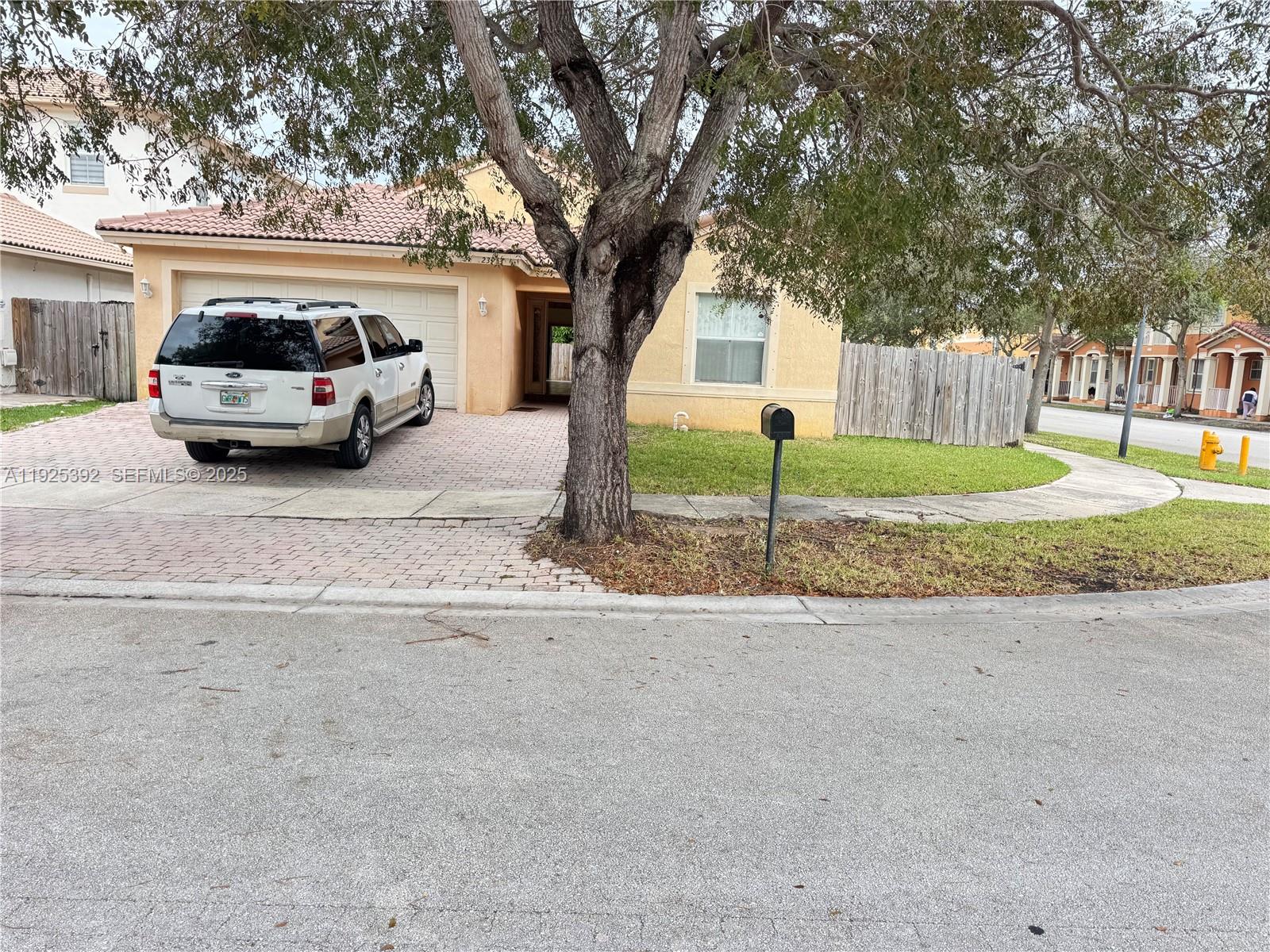 23953 Southwest 108th Court Homestead, FL 33032 - Photo 2 of 25 a view of a car parked in front of a house