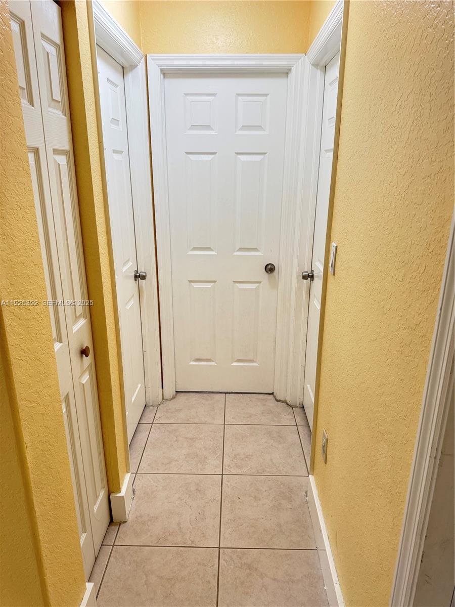 23953 Southwest 108th Court Homestead, FL 33032 - Photo 8 of 25 a view of a hallway with wooden floor